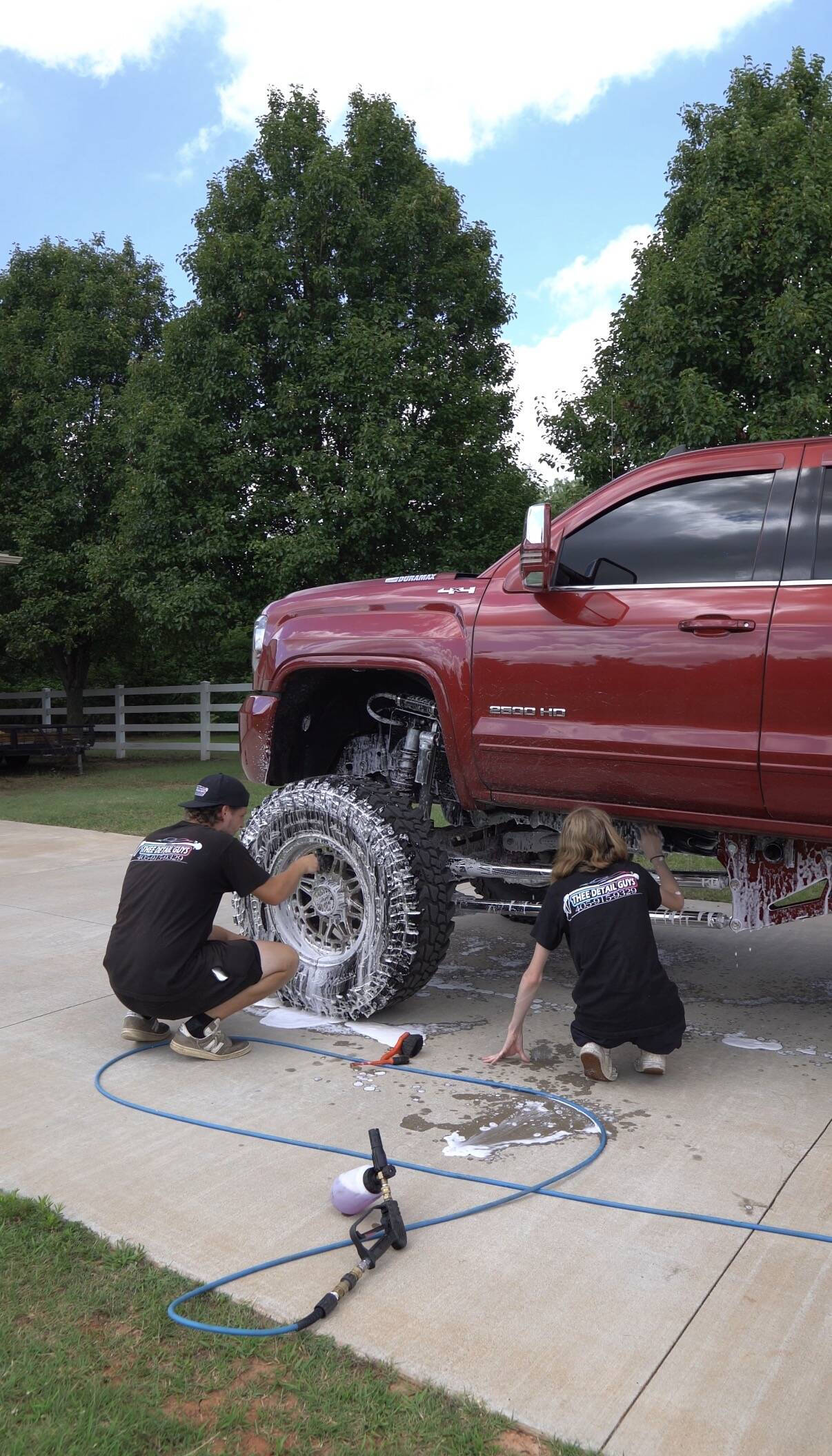 Thee Detail Guys washing a lifted Duramax